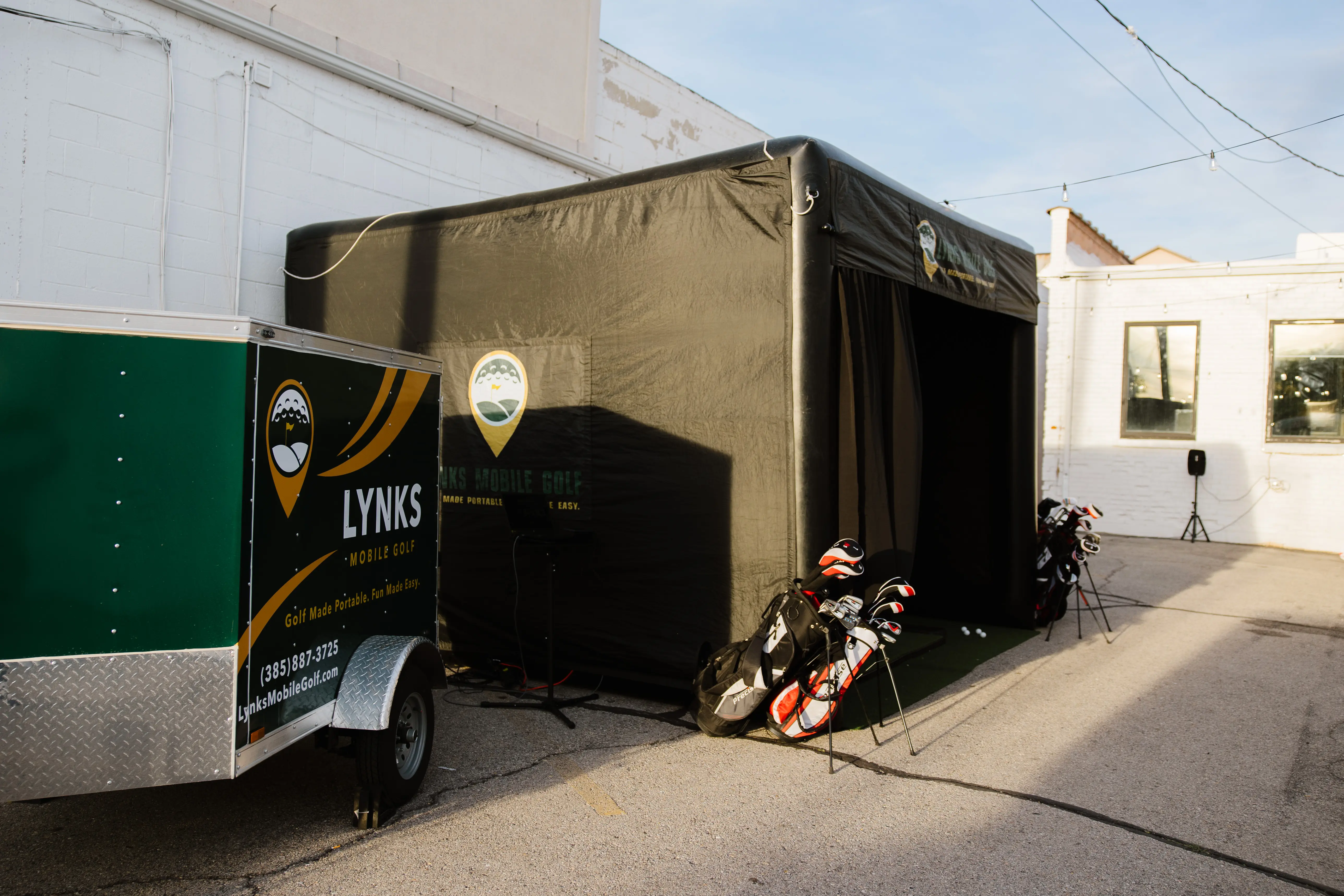 Lynks Mobile Golf simulator bay and trailer setup at a Utah event venue